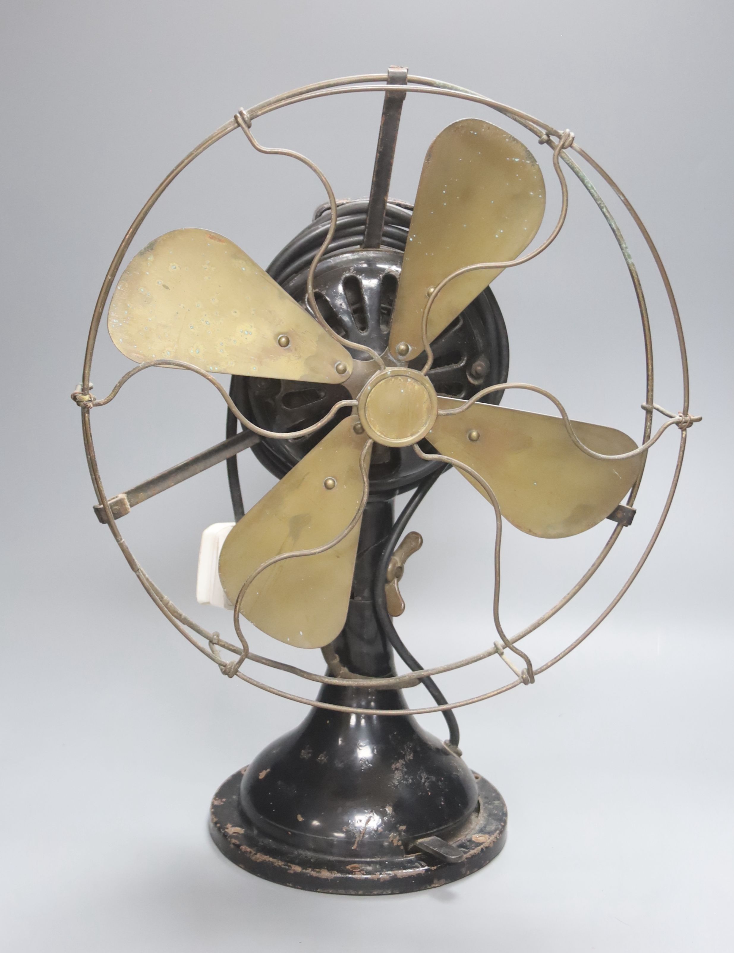 A vintage cast iron and brass propeller desk fan, height 45cm